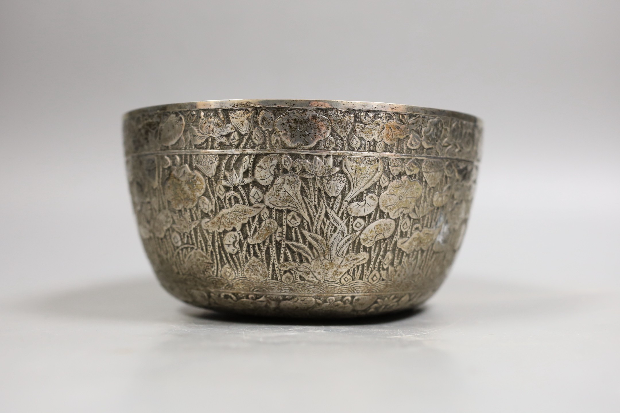An Eastern embossed white metal bowl, diameter 17.7cm, 9.4oz.